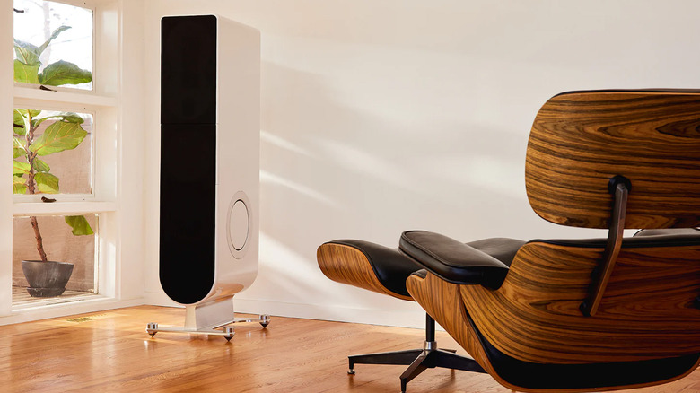 A PS Audio speaker in a room with wood chairs