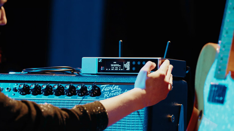A Sennheiser amplifier on top of an instrument amp
