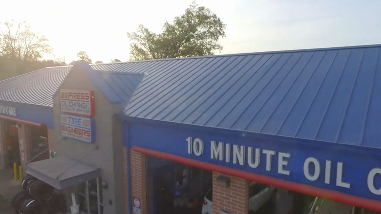 A drone shot of the roof of an Express Oil Change and Tire Engineers building at around sunset.