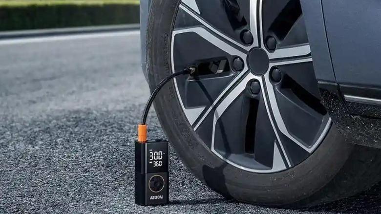 AstroAI L7 tire inflator connected to a car tire.