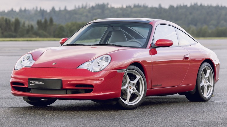 a red 1998 Porsche 911 (996) sitting on the tarmac