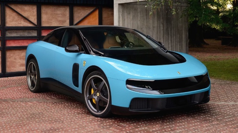 Light blue Ferrari Luce parked in front of a building.
