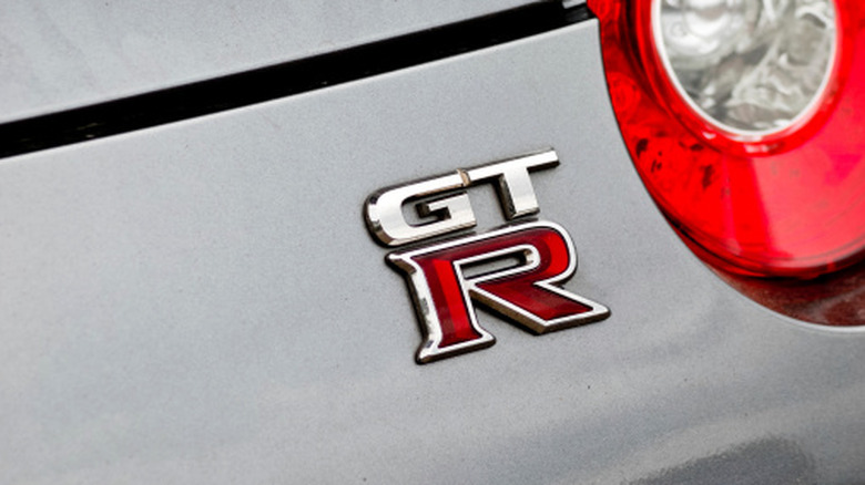 Close-up of GT-R badge on a silver Nissan GT-R R35.