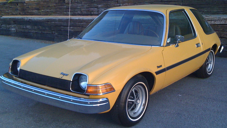 1975 AMC Pacer parked on the road finished in a distinctive 1970s mustard/queso color.