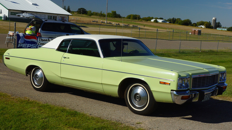 1973 Dodge Polara on a dirt road in a grassy field