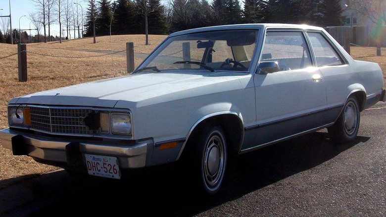 1978-era two-door Ford Fairmont in blue, visible damage to the front grille