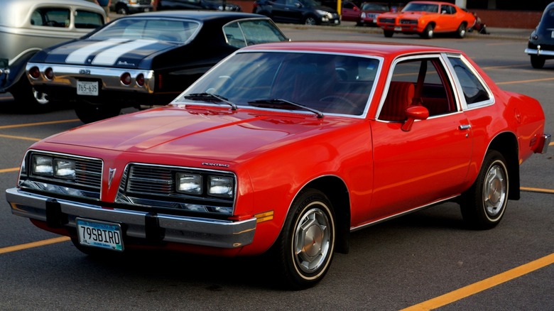 1979 Pontiac Sunbird coupe finished in red, parked in a parking lot.