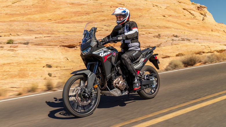 Honda Africa Twin motorcycle riding through the desert.