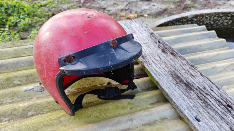 Aged motorcycle helmet on the ground.