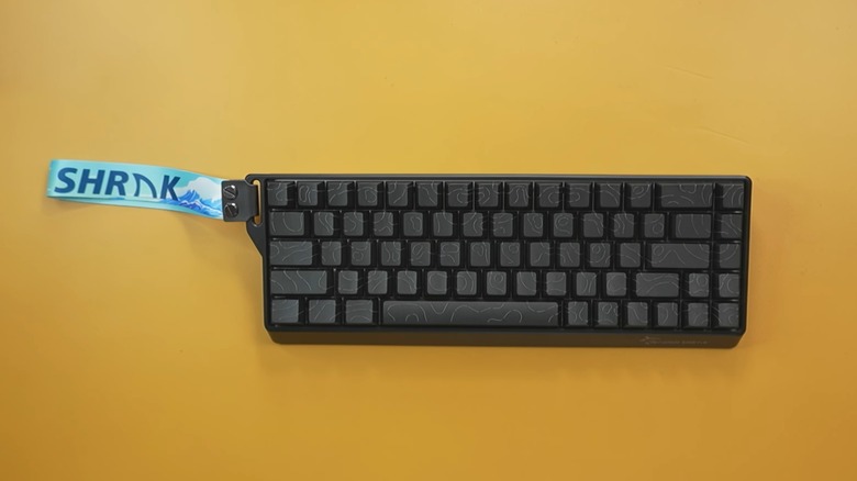 Gamakay x NaughShark NS68 keyboard on an orange surface