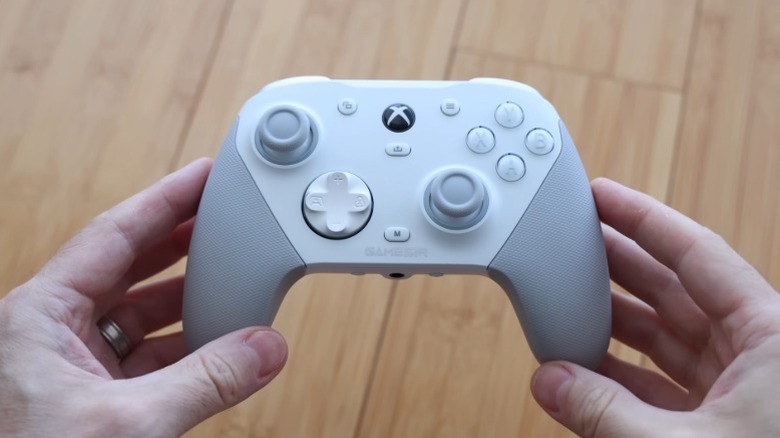 Hands holding a white GameSir G7 Pro controller
