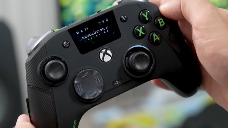 Hands holding a black Nacon Revolution X Unlimited controller