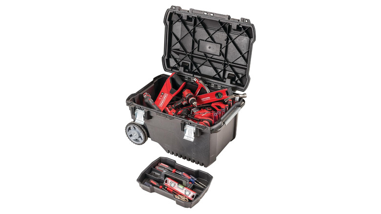 A black toolbox with wheels and a tray, both overflowing with tools