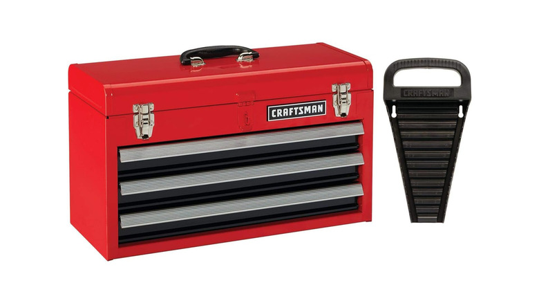 A metal red and black tool chest labeled Craftsman next to a wrench organizer