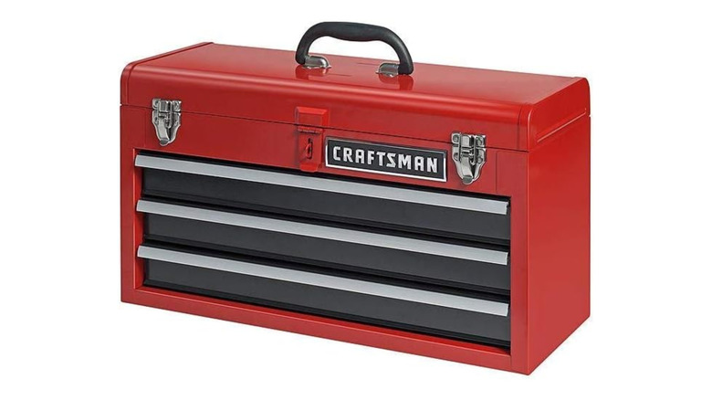 A Steel red and black toolbox with a closed trays and a lid