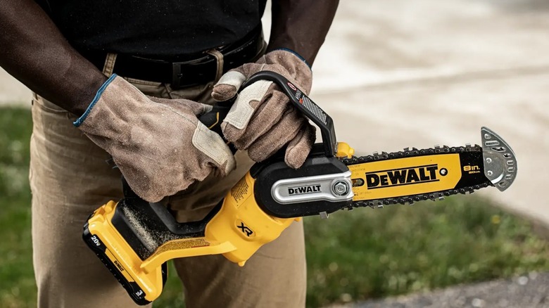 man holding pruning chainsaw
