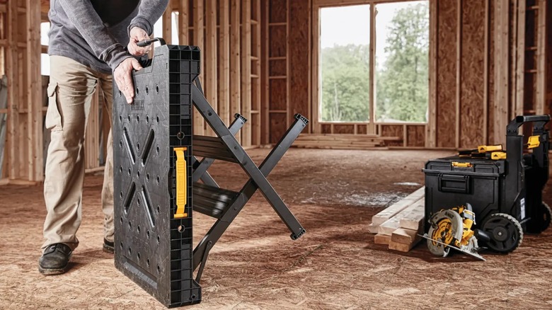 setting up portable sawhorse workbench on jobsite