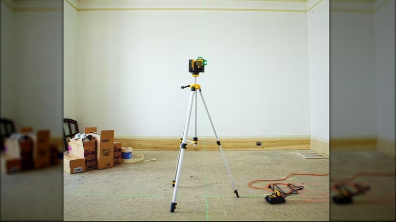 DeWalt laser level and tripod in a room being renovated