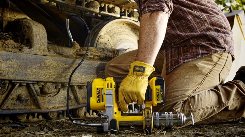servicing construction machinery with DeWalt grease gun