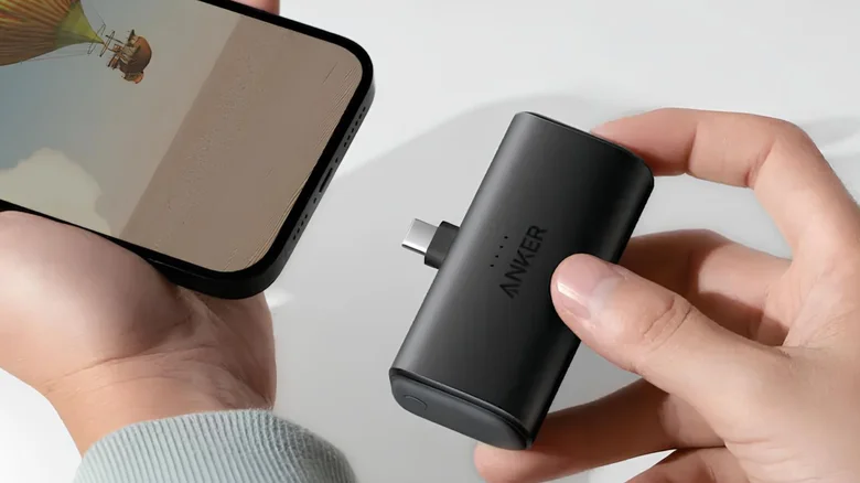 person using ultraportable power bank to charge their phone
