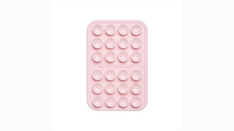 Pink silicone suction phone mount on white background