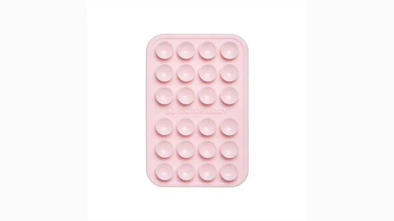 Pink silicone suction phone mount on white background