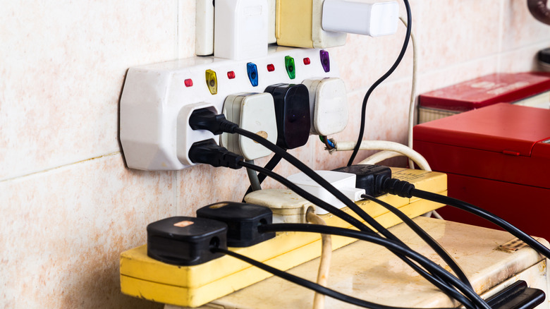 An old surge protector with a bunch of plugged-in devices