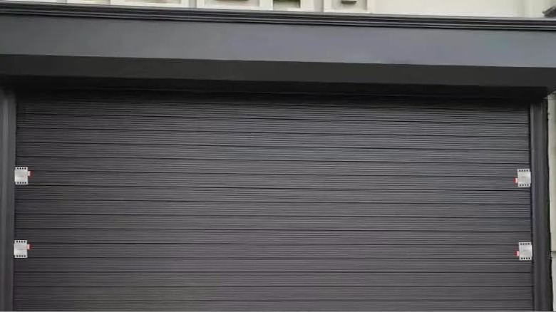 A garage door with locks on the sides.