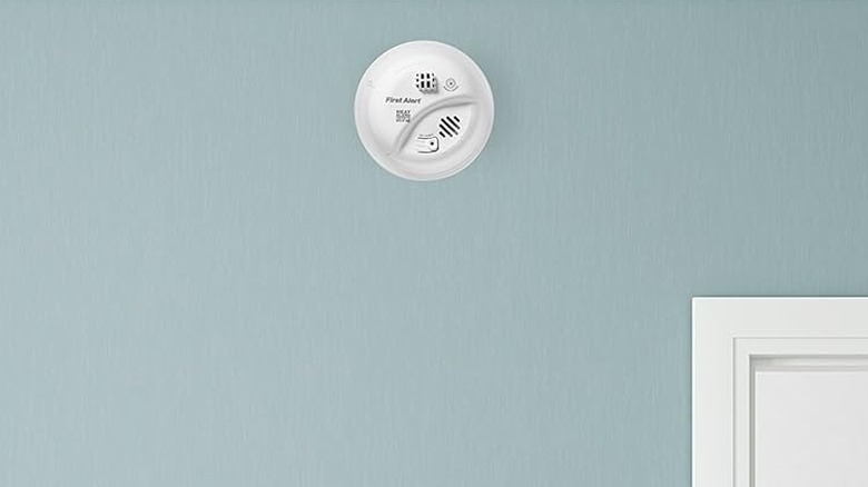 A heat detector on a wall.