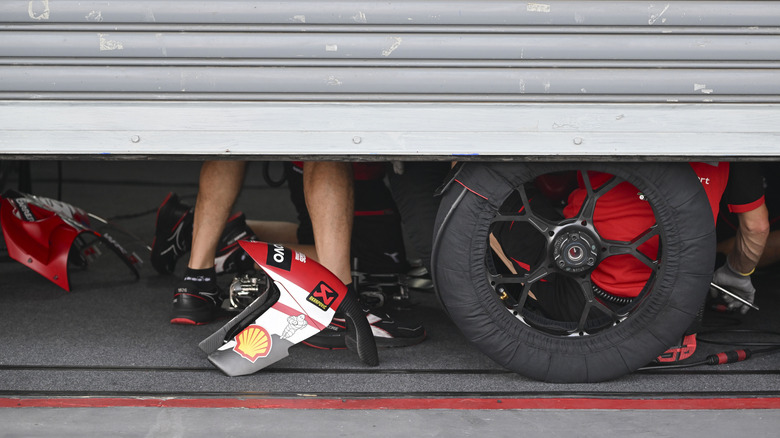 The Lenovo Ducati under the garage door in pit lane during MotoGP testing.