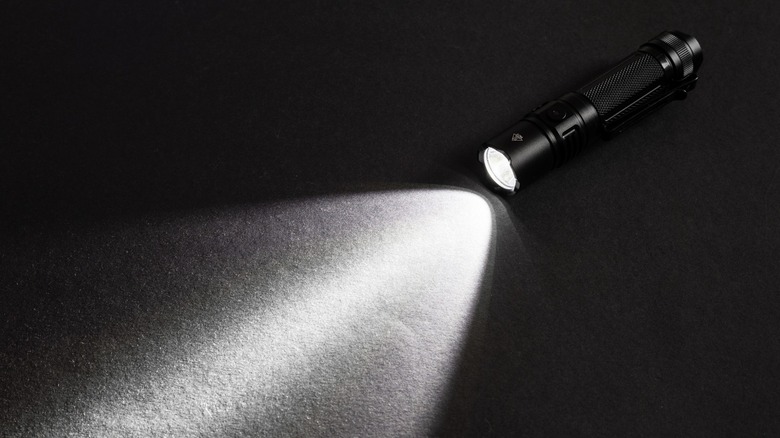 a black flashlight on the floor