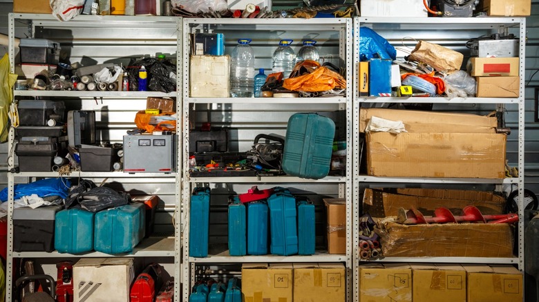 a shelf in a garage containing various supplies