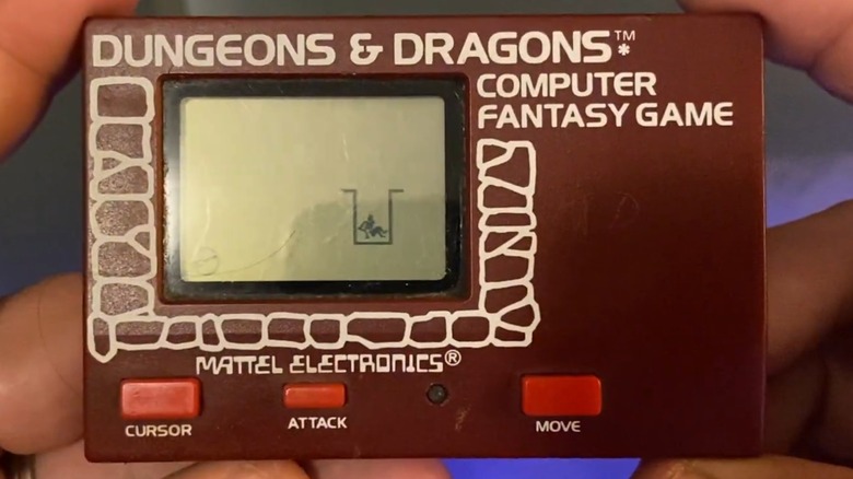 A person holding the Mattel Electronics Dungeons & Dragons Computer Fantasy Game