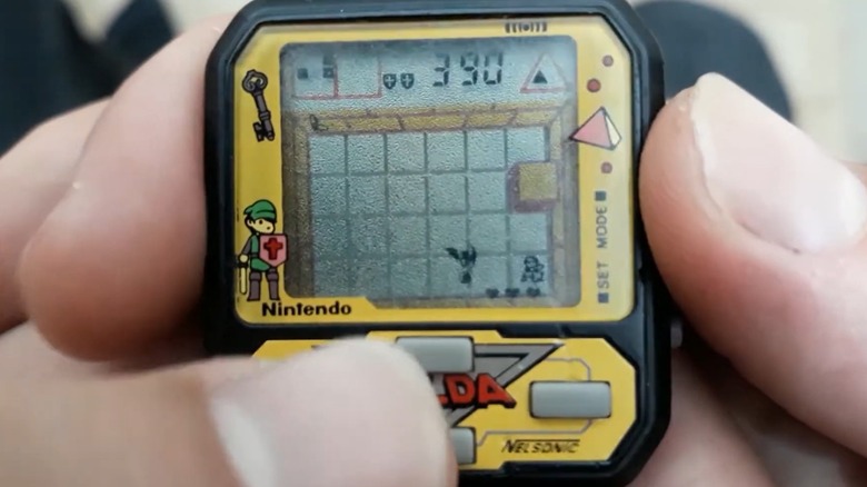 A person playing the Nelsonic The Legend of Zelda Game Watch