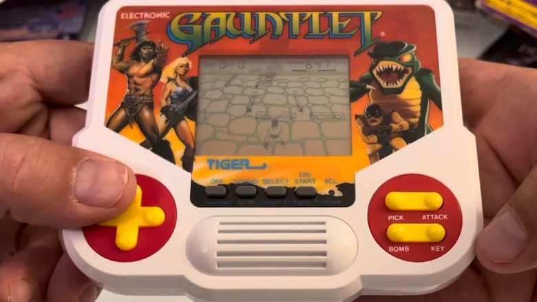 A person playing the Tiger Electronics Gauntlet handheld game