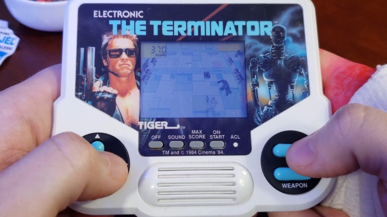 A person playing the Tiger Electronics The Terminator handheld game