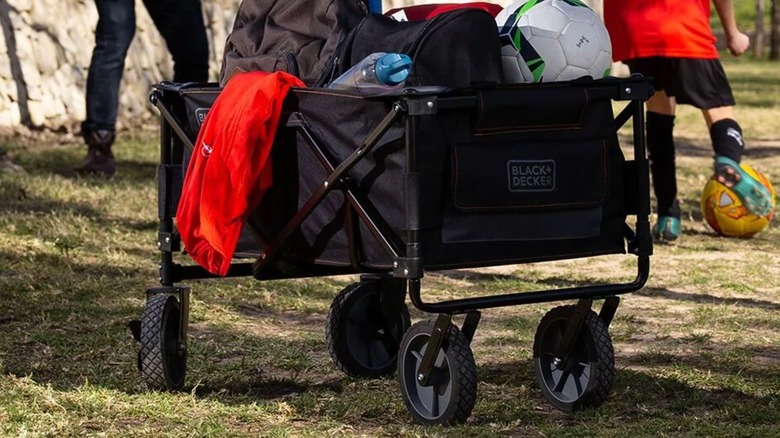 Black & Decker Collapsible Storage Cart holding sports equipment