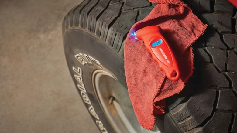 A Craftsman tire gauge on a car tire.