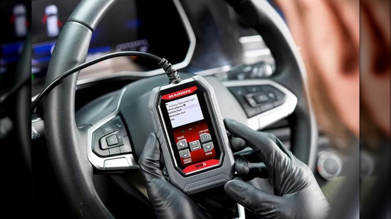 Maddox MR5 OBD2 Code Reader in front of wheel