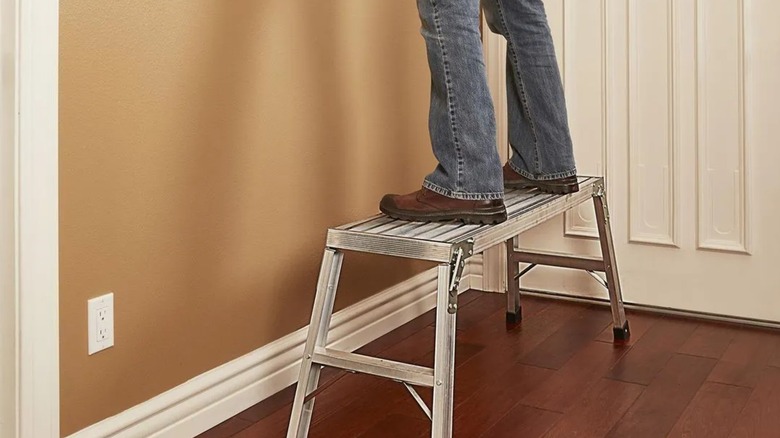 standing on Franklin work platform in house