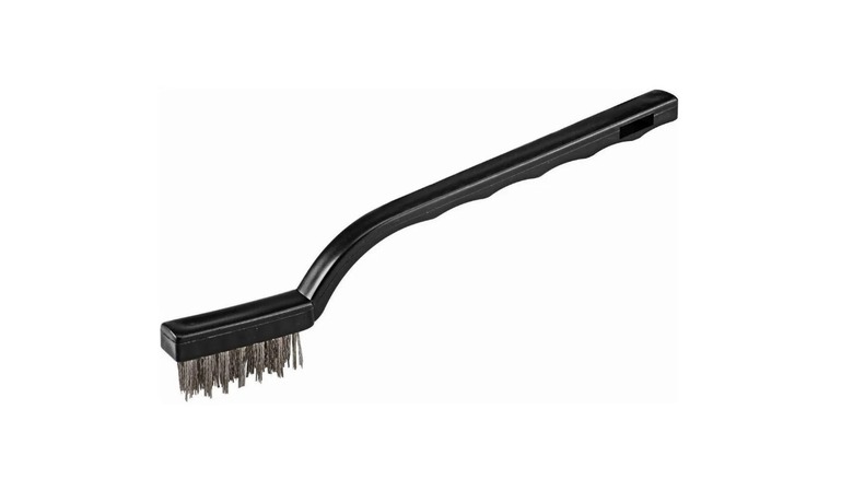 Stock image of black long-handled brush with steel bristles