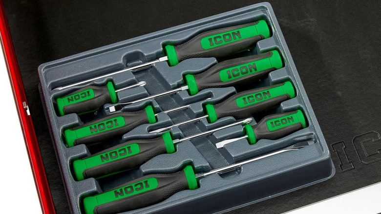 A green Professional Mechanics Screwdriver Set on a black leather surface