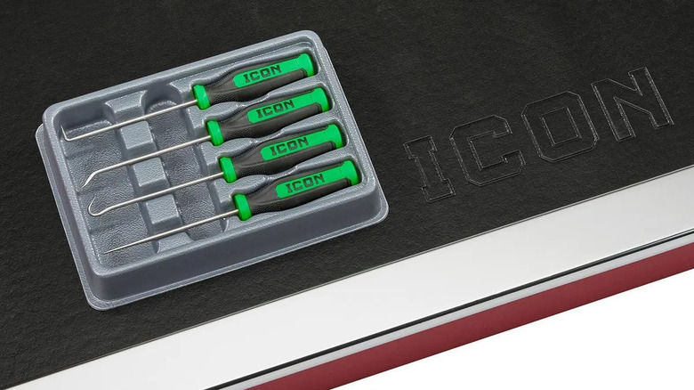 A green Professional Mini Soft-Grip Pick and Hook Set on a black and white surface, with the letters "ICON" spelled out next to it