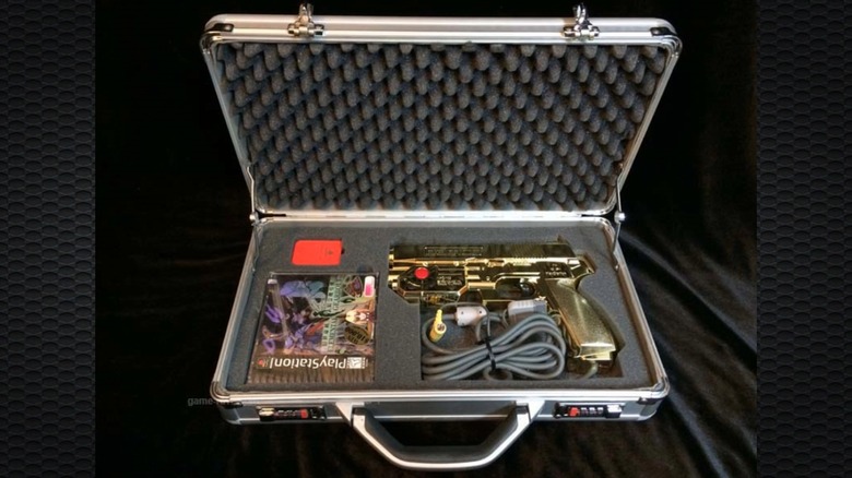 An open Elemental Gearbolt Assassin Case showing the game and light gun