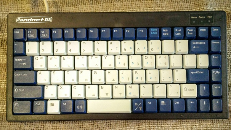 The Nintendo 64DD Keyboard against a patterned cloth background
