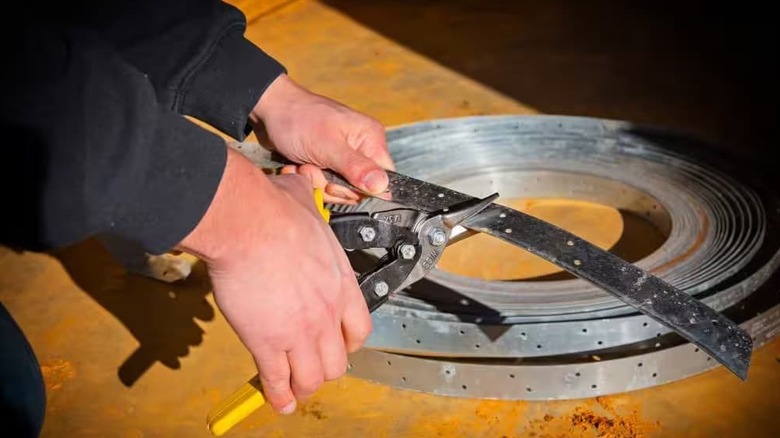 Some compound aviation snips being used on metal.