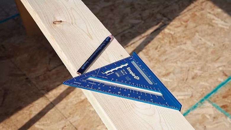 A Laser etched rafter square next to a pencil.