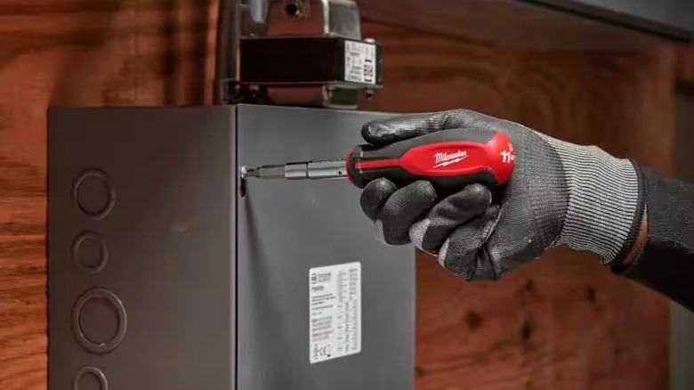 A wrench in use on a box.