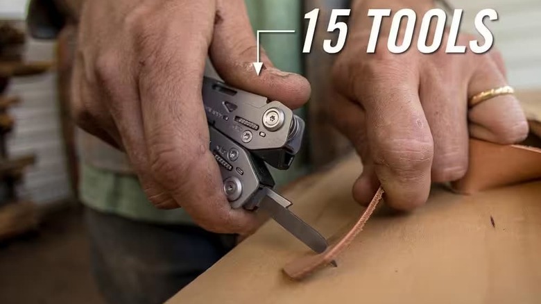 A multi-tool cutting through leather.
