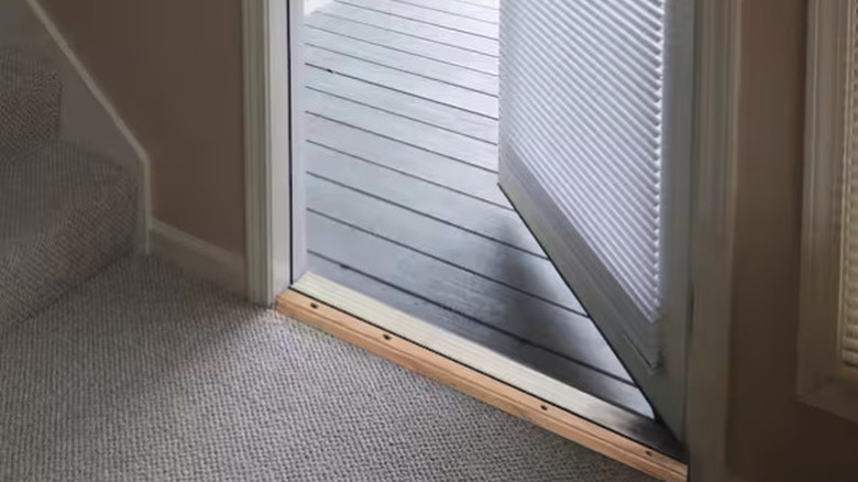 Frost King Adjustable Threshold Weatherstrip on display in door frame